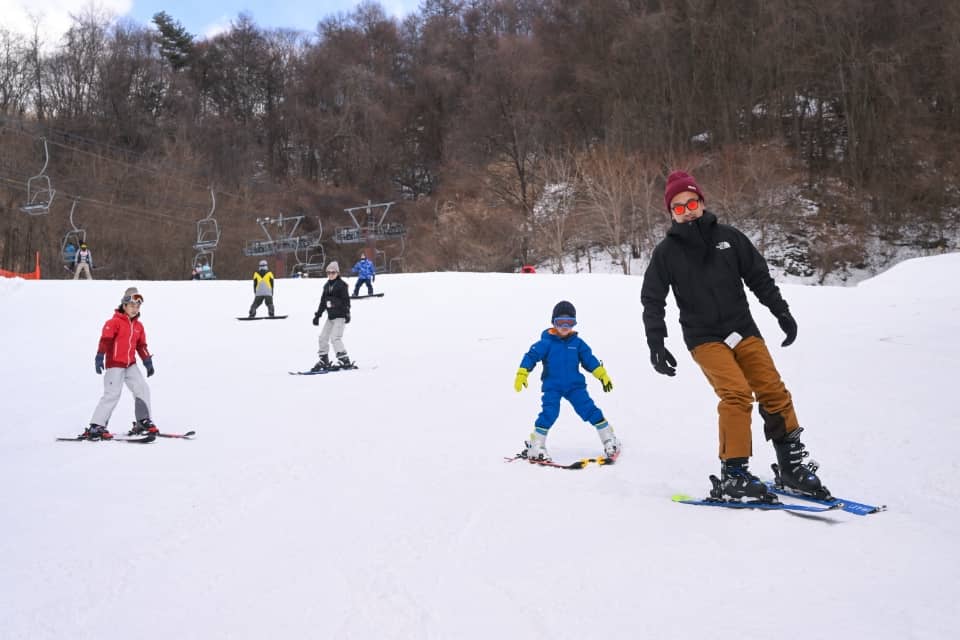 緩やかな斜面を滑る子どもと大人